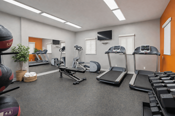 Fitness room with cardio machines and free weights
